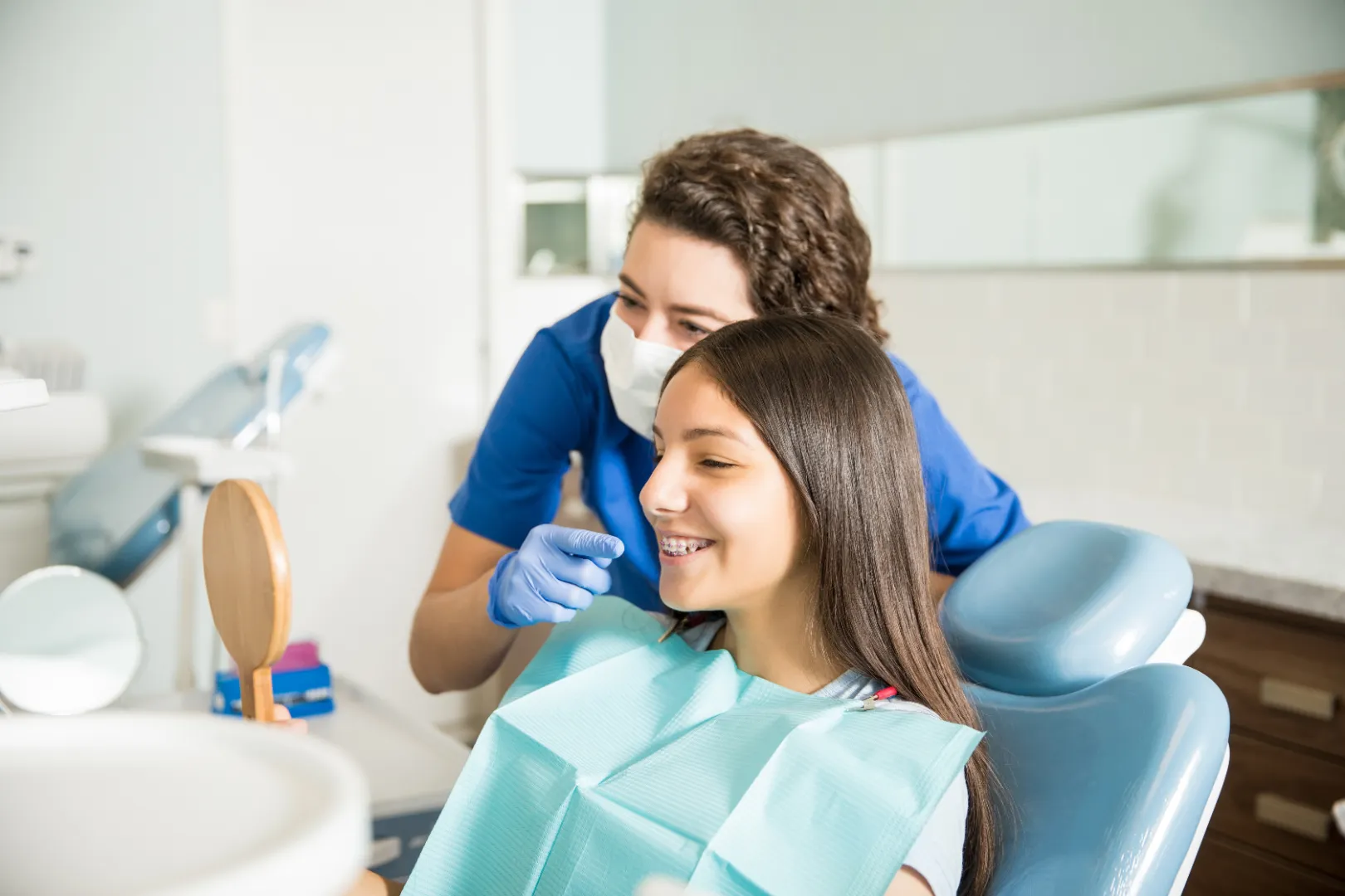 Young patient reviewing smile with dental team