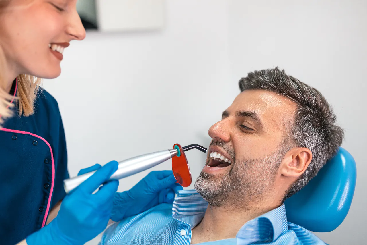 A composite filling being cured during a routine visit