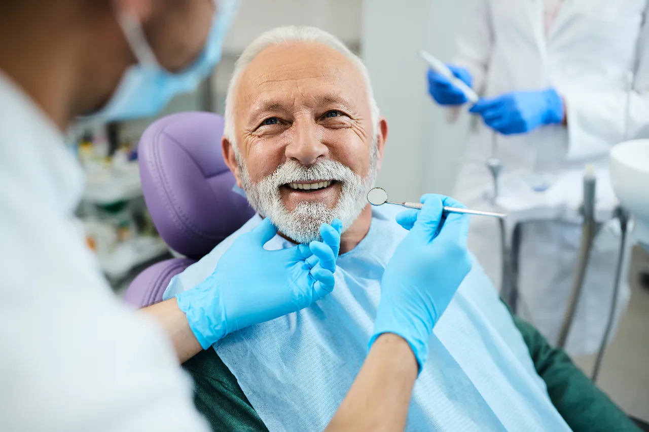 A denture patient having the fit checked at Isom Dentistry